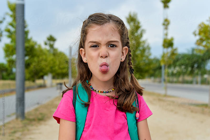 Little girl sticking her tongue out after school
