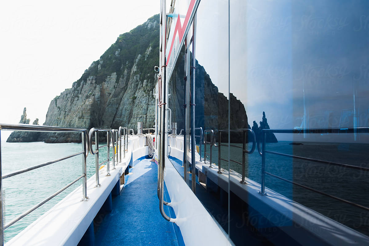 Island reflection in window of cruise ship