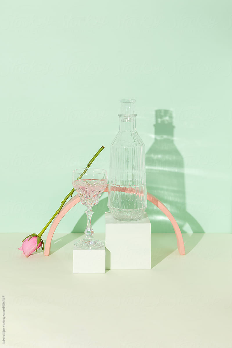 Glass textured bottle, soft drink, pink rose and boxes against g