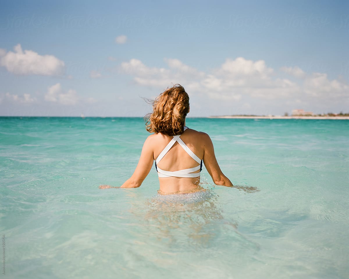 Beautiful Woman In A Bathing Suit Standing In An Ocean By Stocksy Contributor Jakob