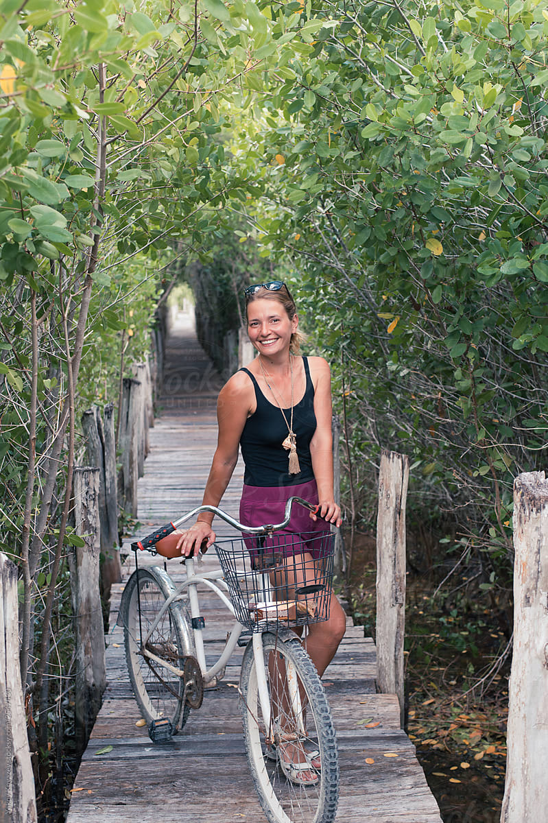 Woman Riding A Bicycle Through a jungle Park in Mexico