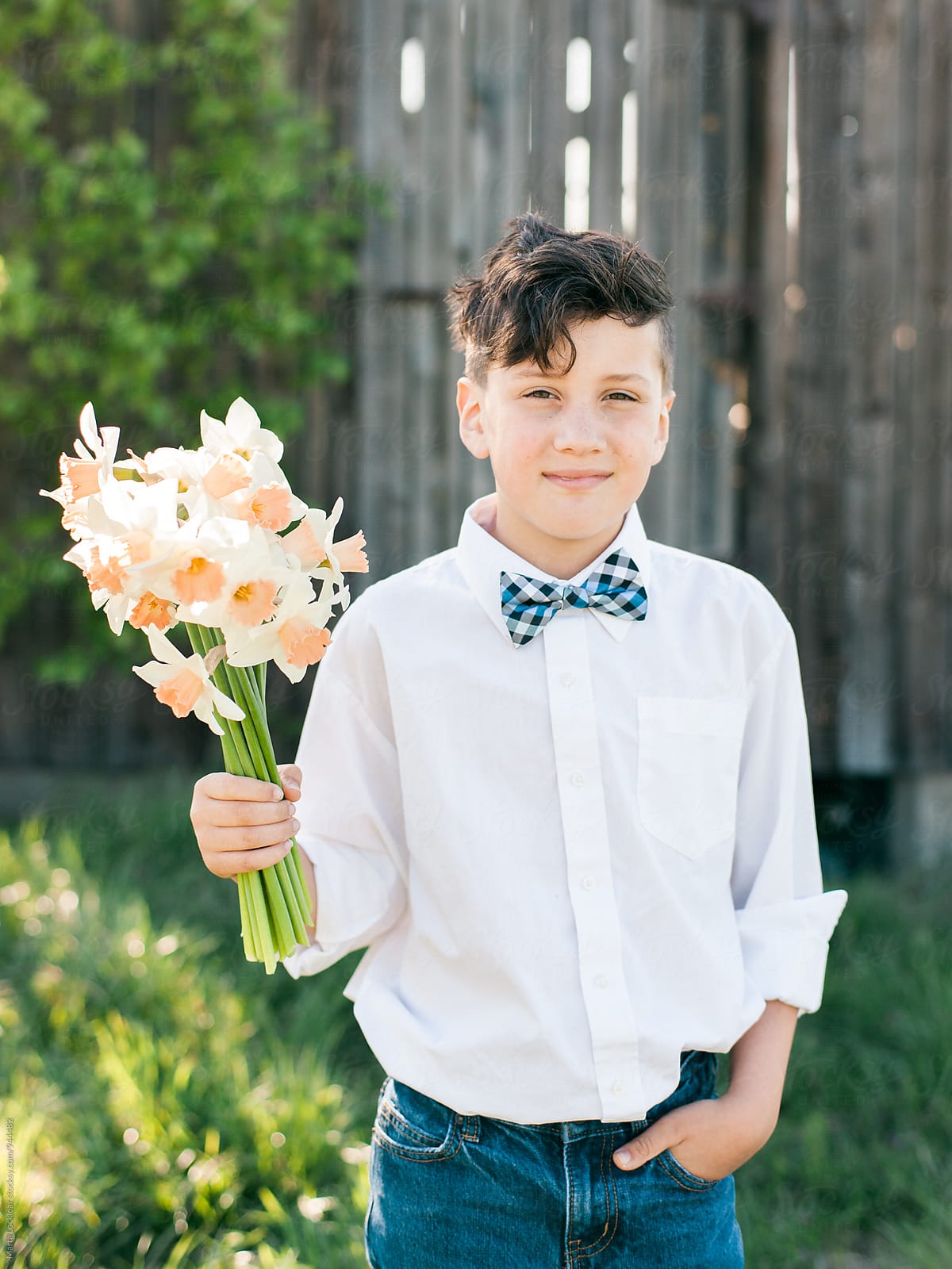 Boy in bow tie with a bouquet of Daffodils