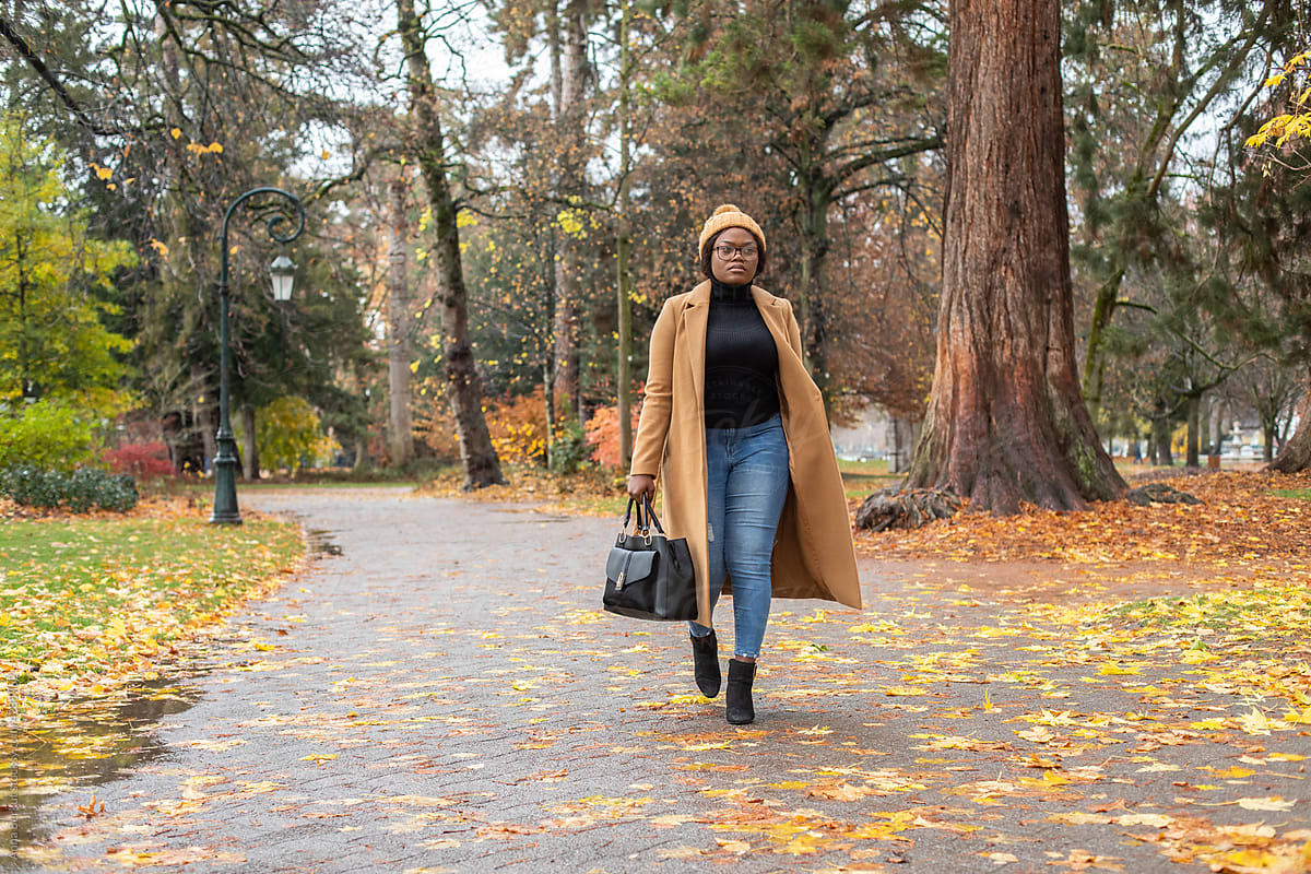 black woman wearing beanie and warm coat, autumn