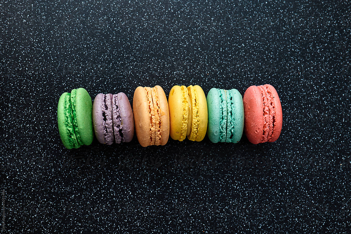Bright colourful macaroons on a dark background