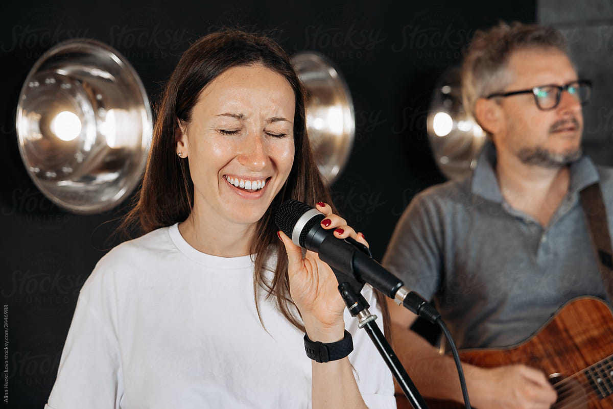 Creative woman singing in studio