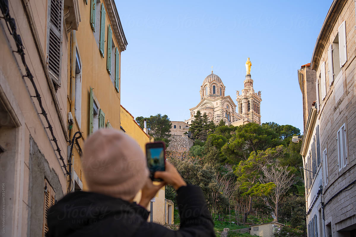 Tourist Taking A Photo Of Marseille Basilica.