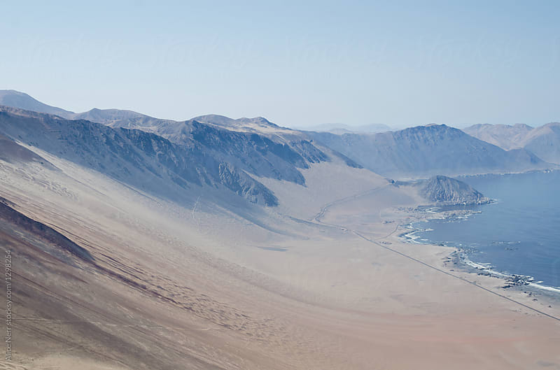 View to colorful sands of desert, highway and ocean