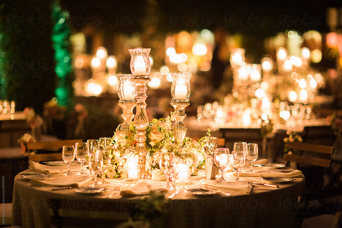 A candlelit elegant Italian wedding Reception in a clear marquee