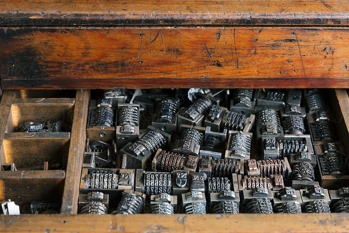 Close up of old wood drawer filled with vintage metal numbering inserts for printer