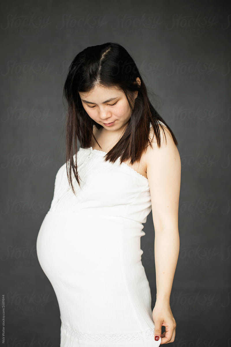 Young Pregnant Chinese Woman In Studio
