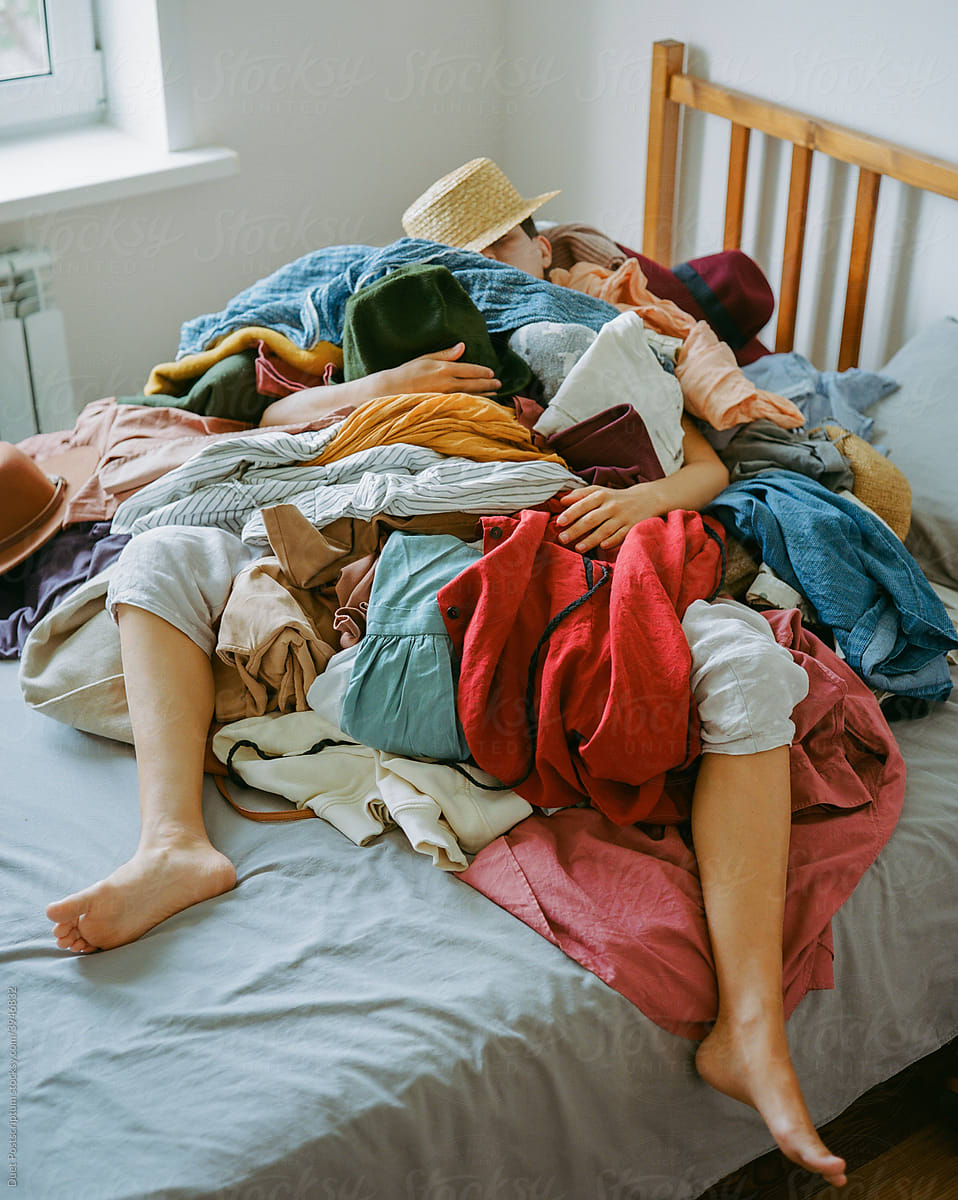 Women under a big mountain of clothes