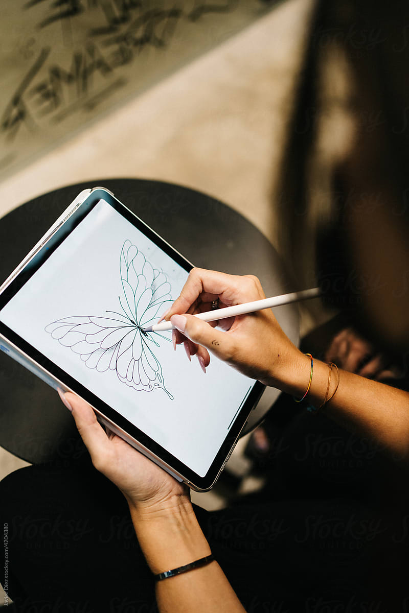Woman drawing sketch on tablet