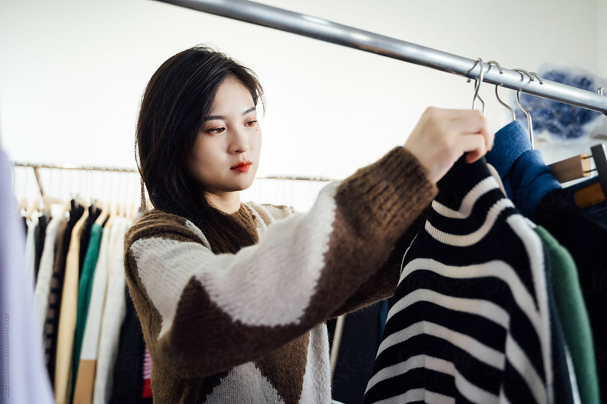 Young woman buying clothes in store