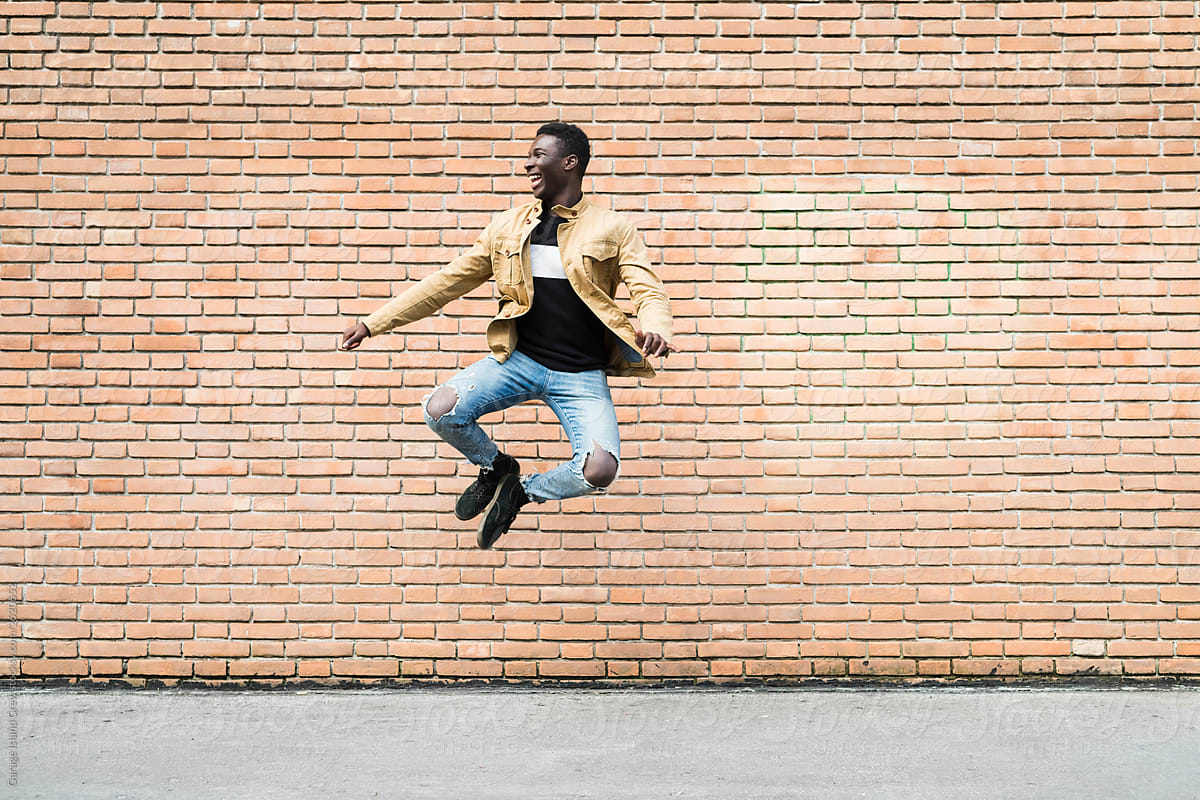 Man jumping against a wall