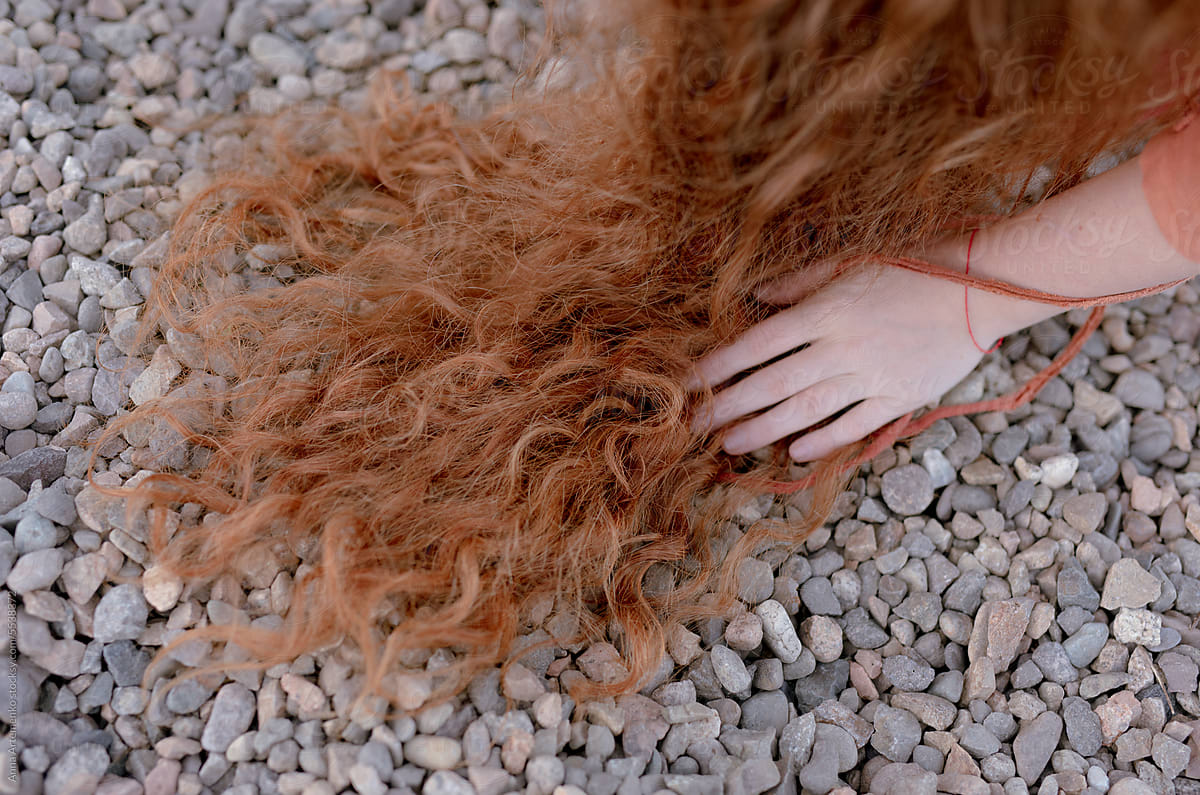 hair of a red-haired woman on the coast of the river