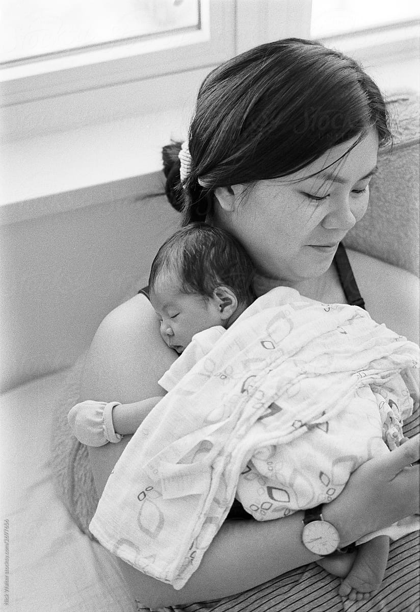 Young Chinese Mother Nursing Her Newborn Daughter