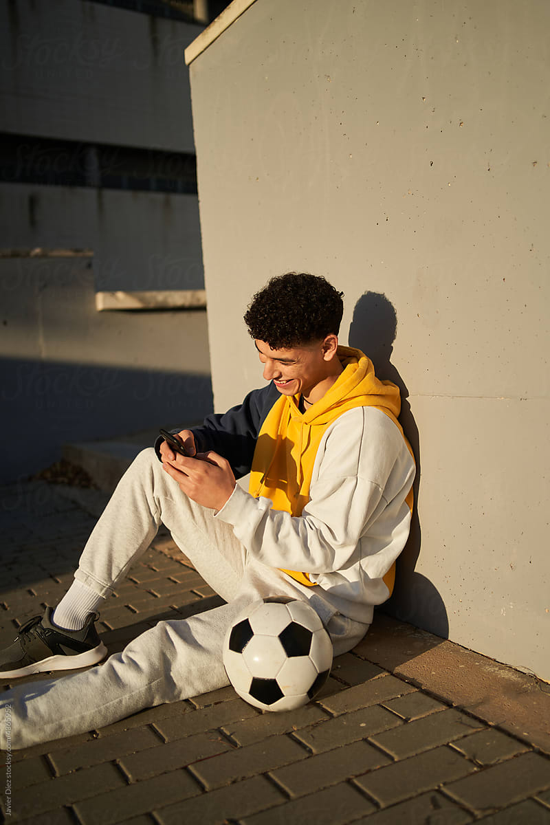 Soccer player using smartphone after training