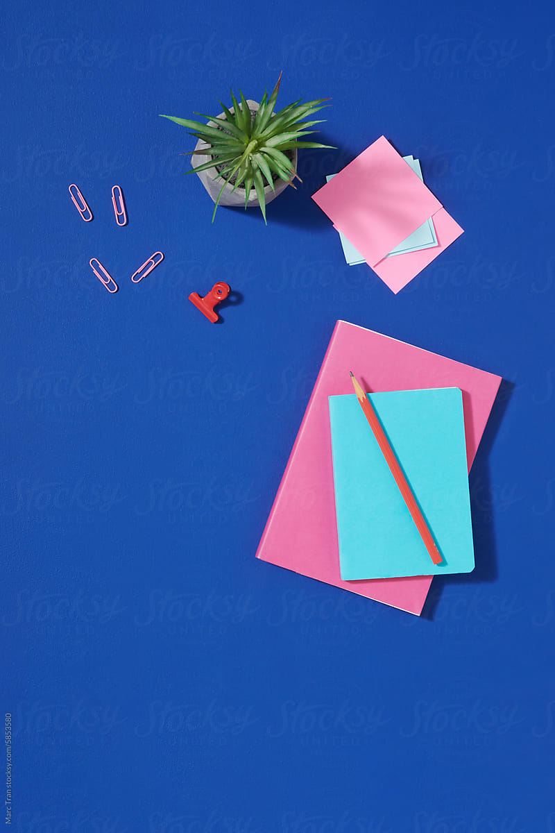 Top view flat lay workplace on blue table