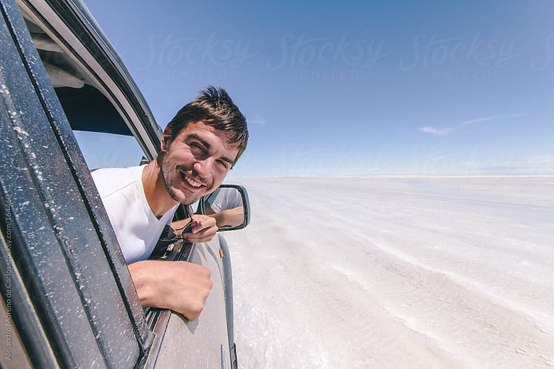 Young man on all terrain car on adventure travel in Uyuni, Bolivia