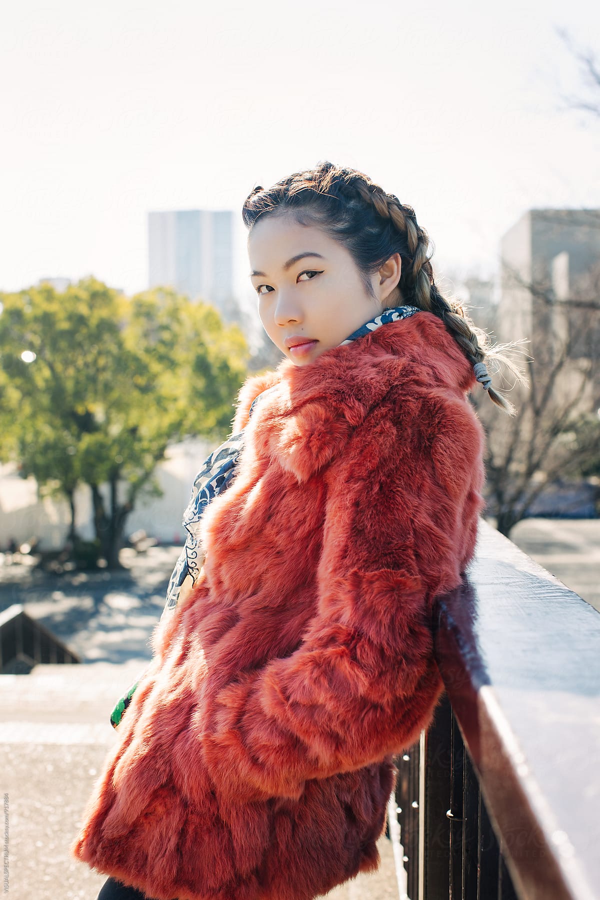 Outdoor Portrait Of Young Pretty Asian Girl In Red Fur Coat By