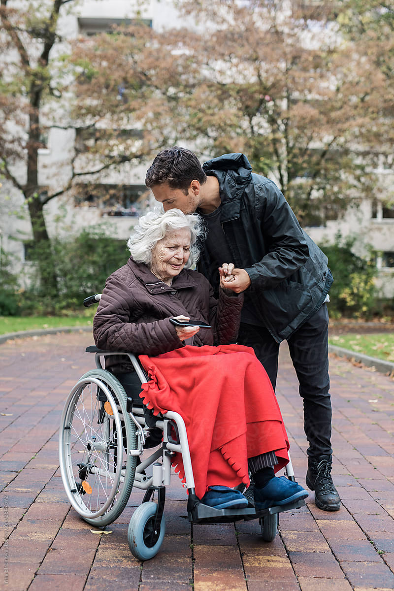 Old woman in a wheelchair with grandson