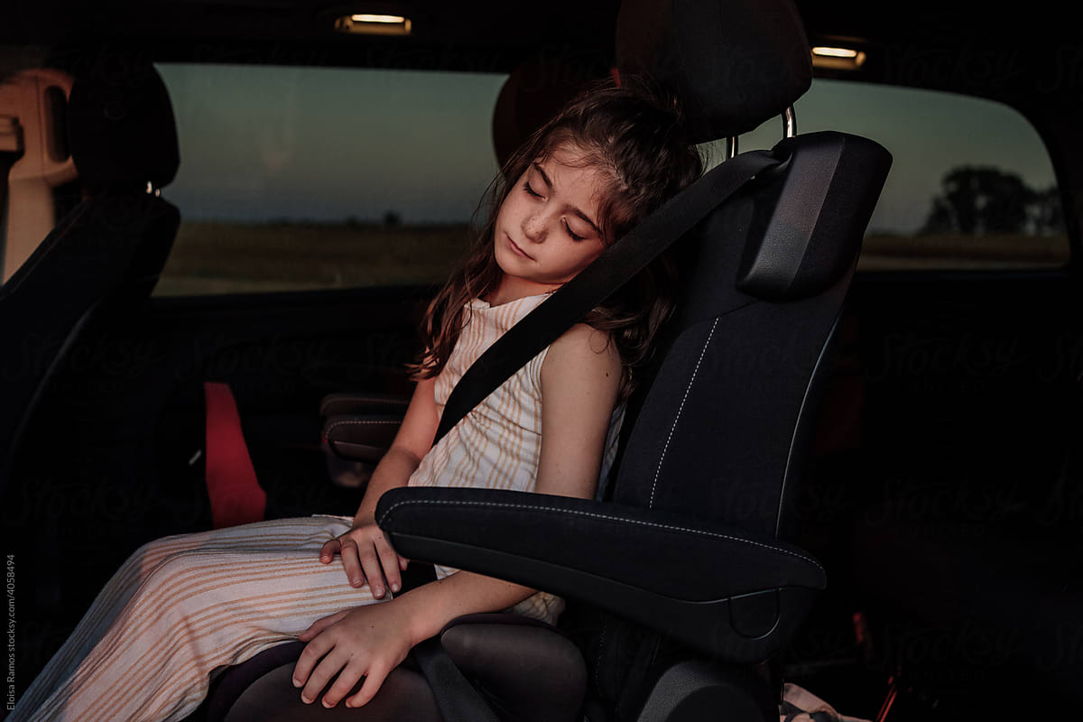 Young girl sleeping iside a car