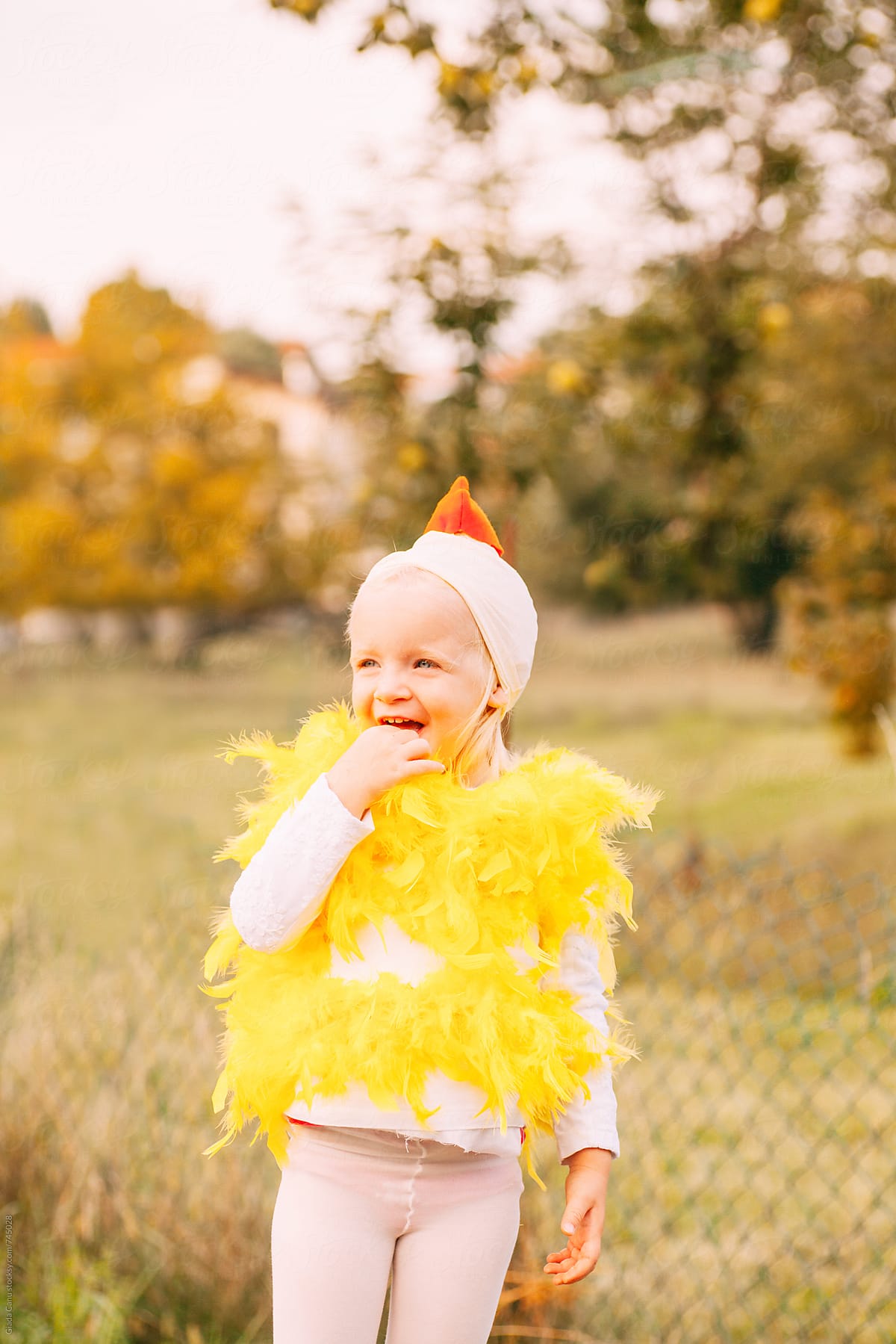 toddler laughing in a chicken costume
