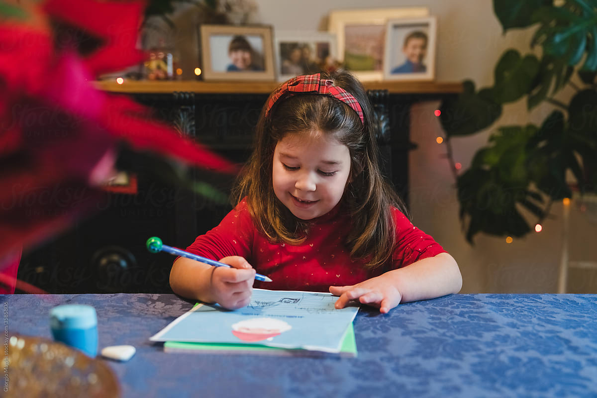 Happy Child Writing Letter to Santa Claus