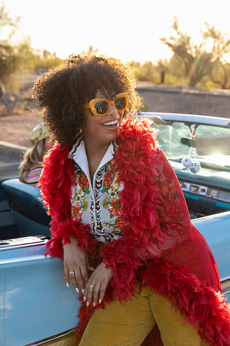 Portrait of African American Woman next to Vintage American car