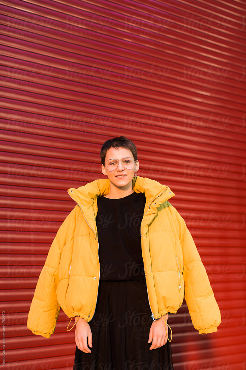 Happy young woman wearing yellow puffer jacket