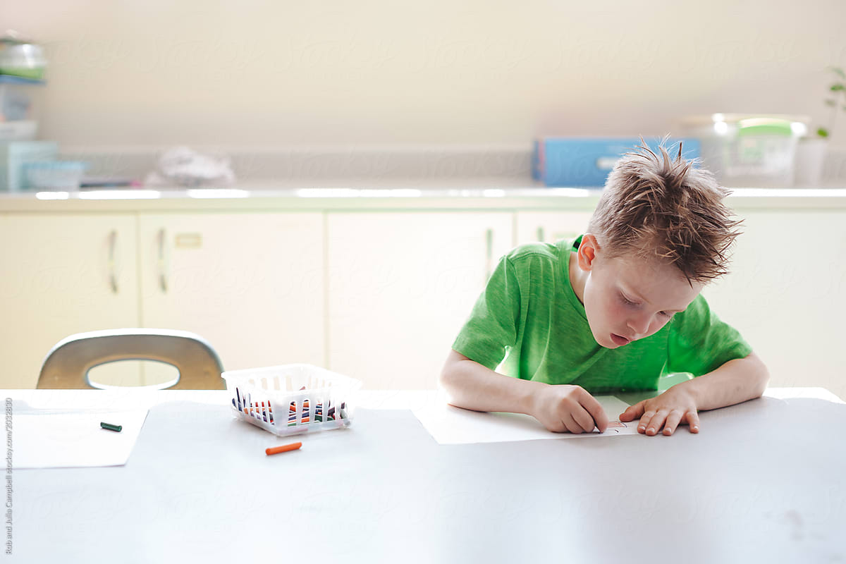 Young kid drawing in classroom