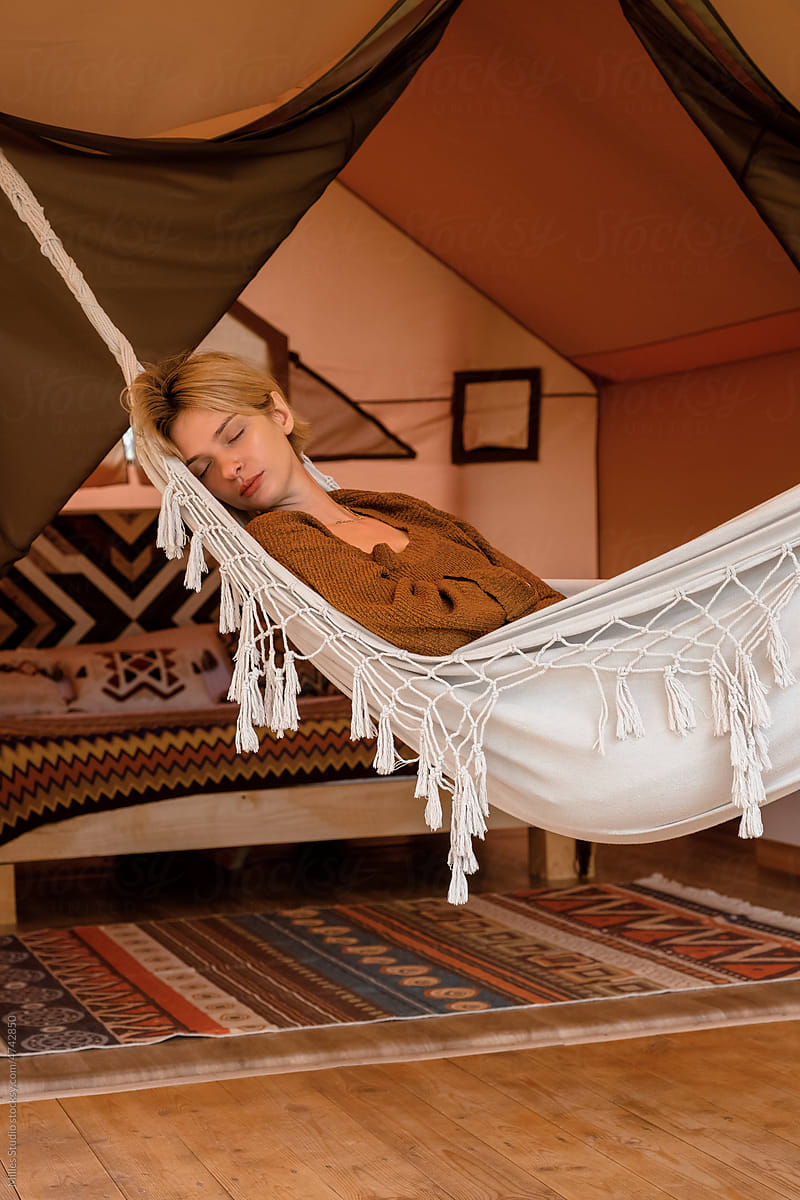 Young woman sleeping in hammock on resort
