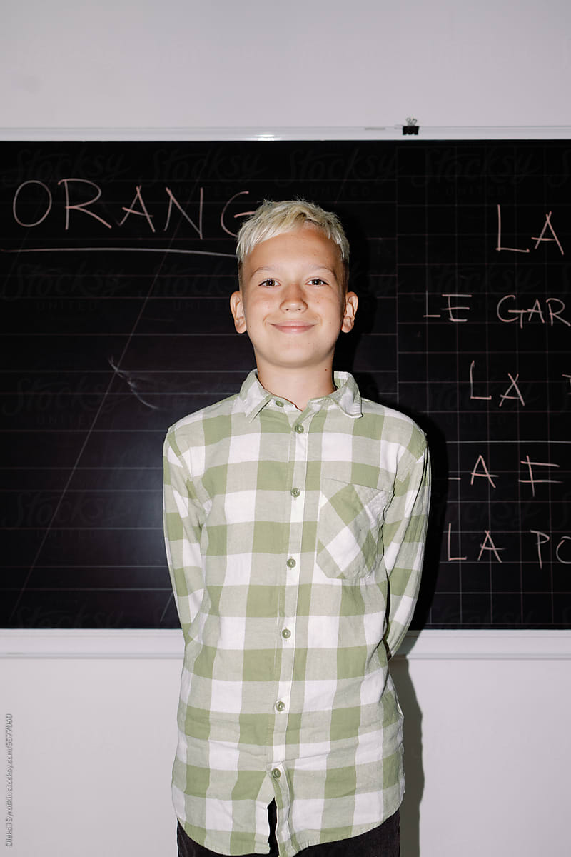 Schoolboy glad foreign language chalkboard back to school eye contact