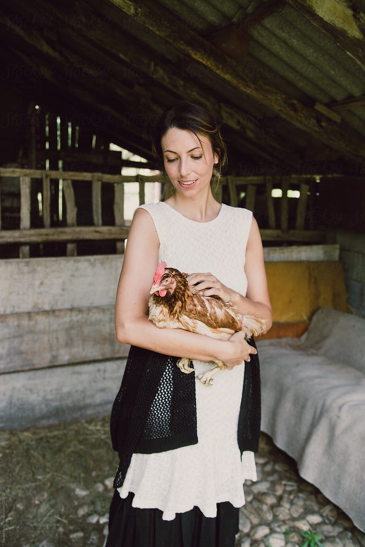 Portraits of a woman in the countryside holding chicken