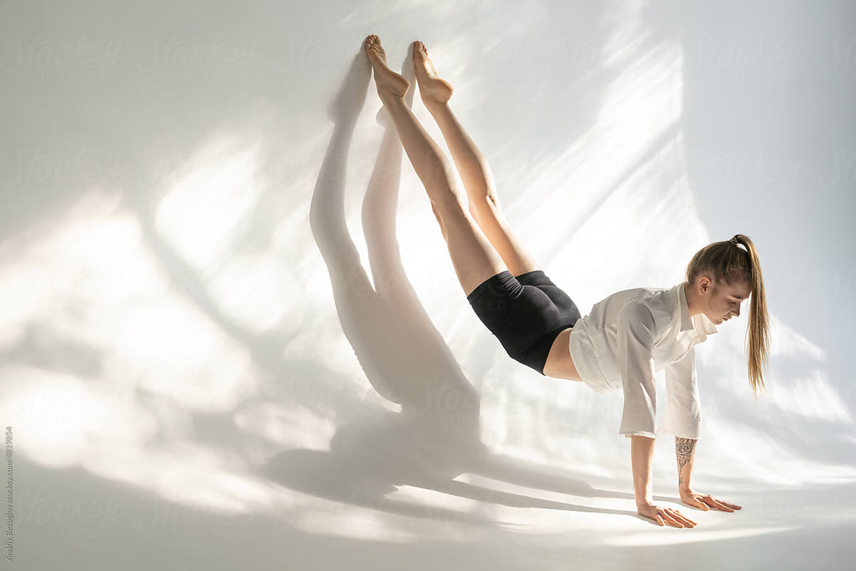 Female acrobat showing her capabilities in studio