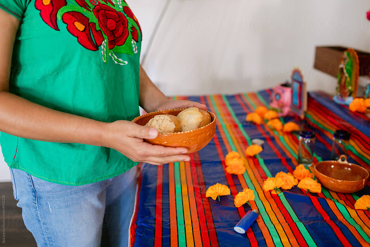 woman  holding bread for ofrenda\'s altar