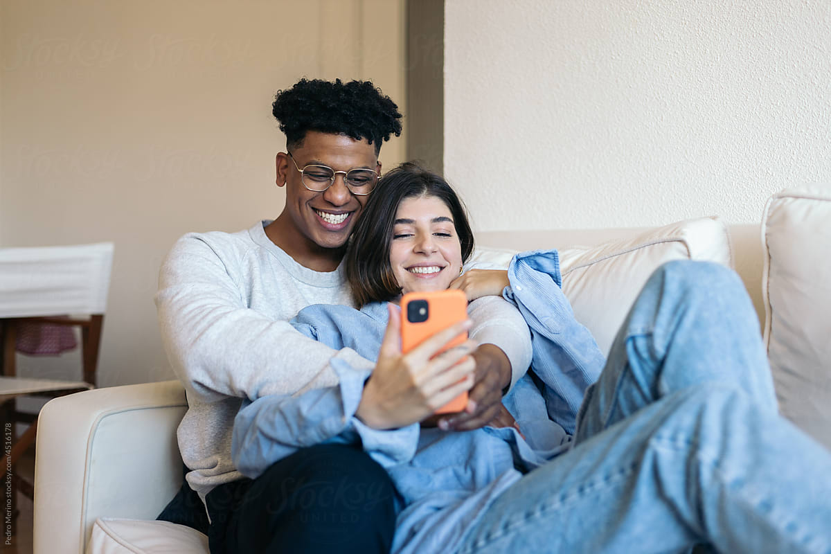 Young couple with smartphone at home