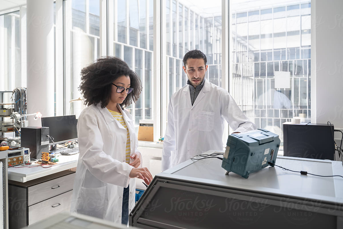 Scientists Monitoring Equipment In Biomechanics Lab