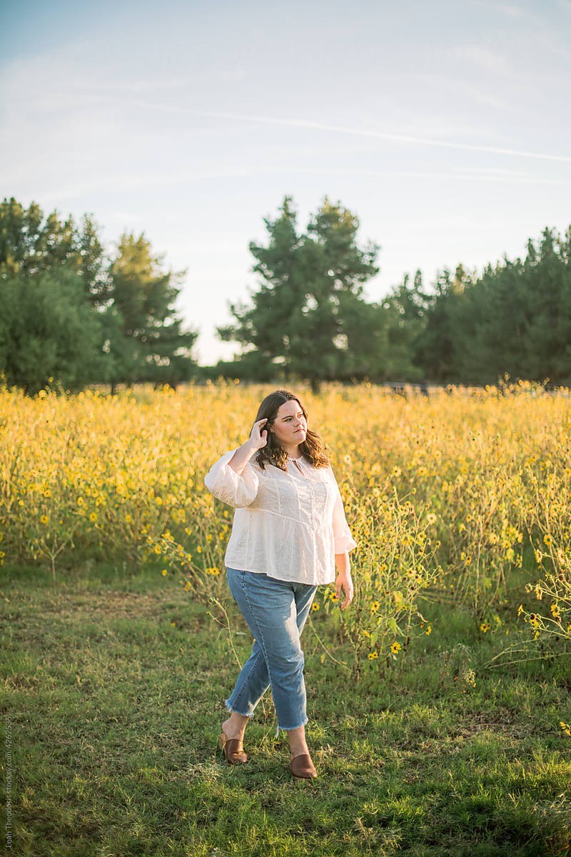 Plus Size Woman Walking Through Wild Sunflower Field