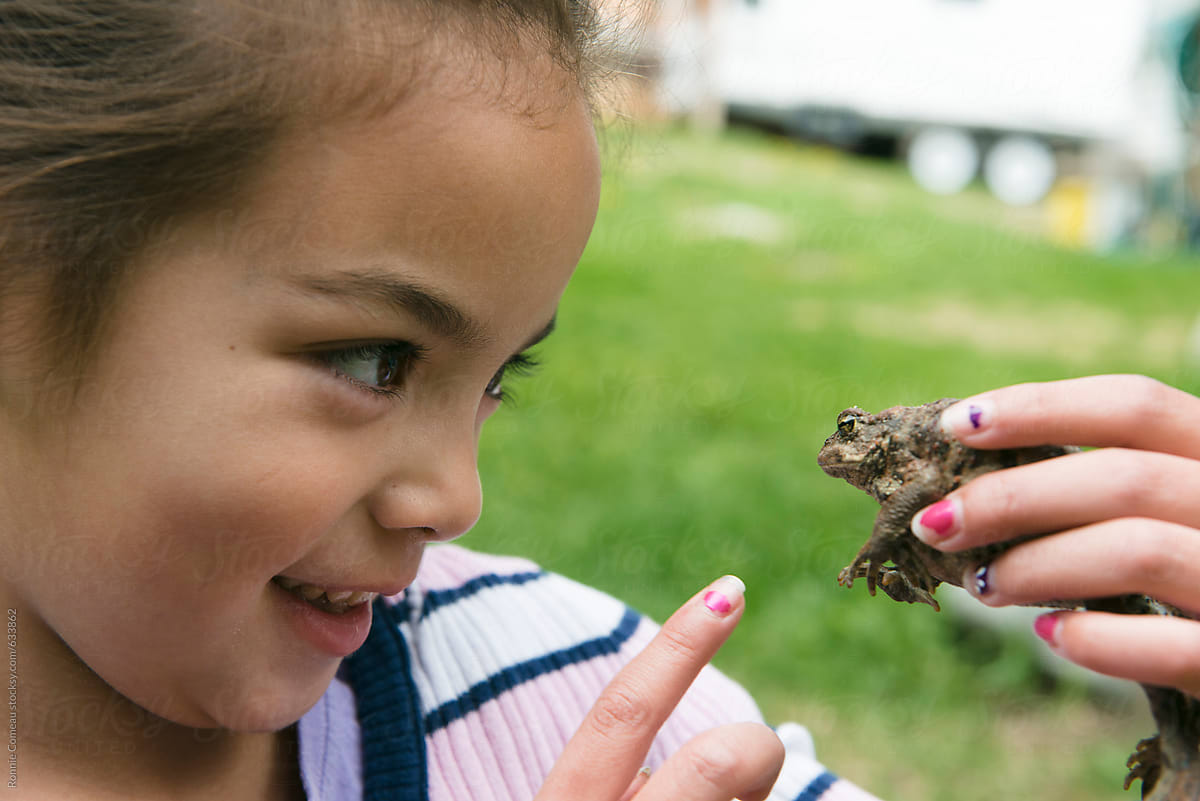 Little Girl Plays With Toad