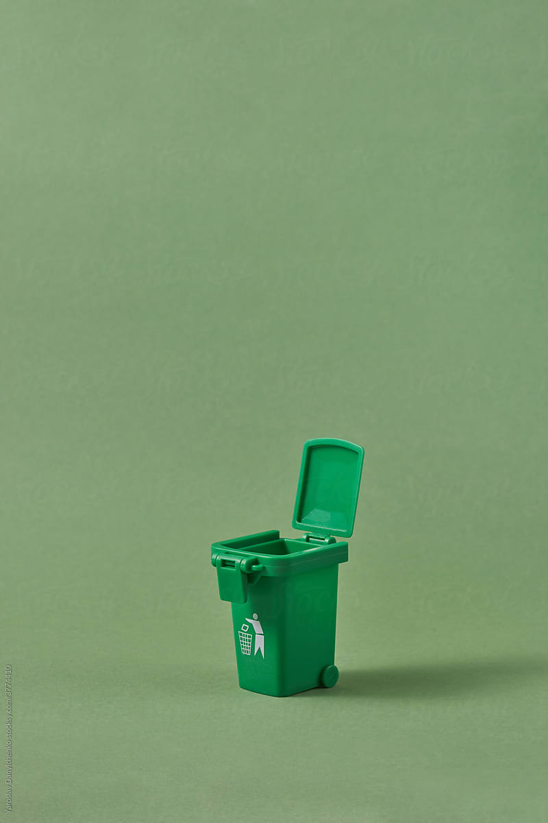 Small open green trash can