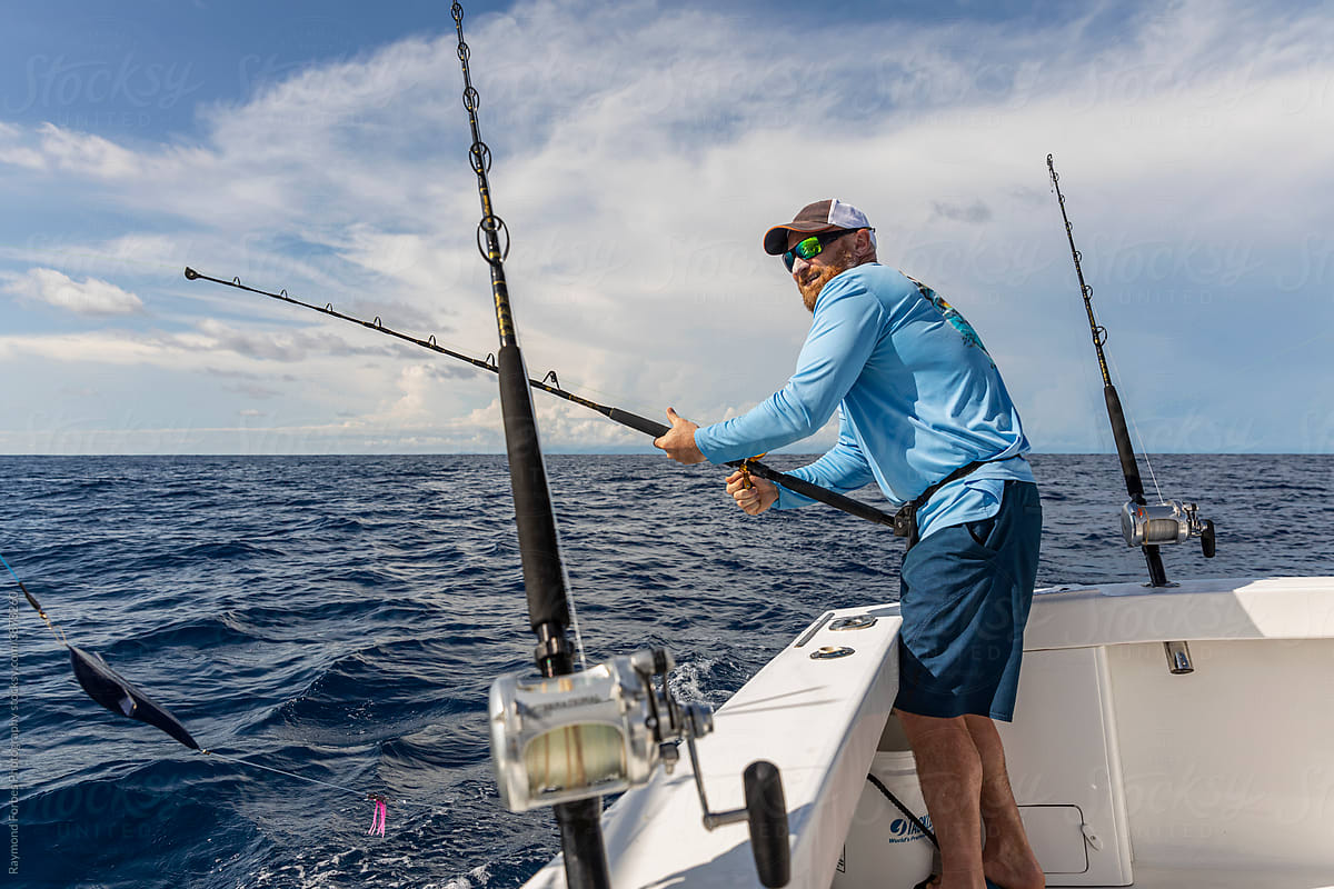 Deep Sea Sportfishing With Fishing Rods In Holder by Stocksy Contributor  Raymond Forbes LLC - Stocksy