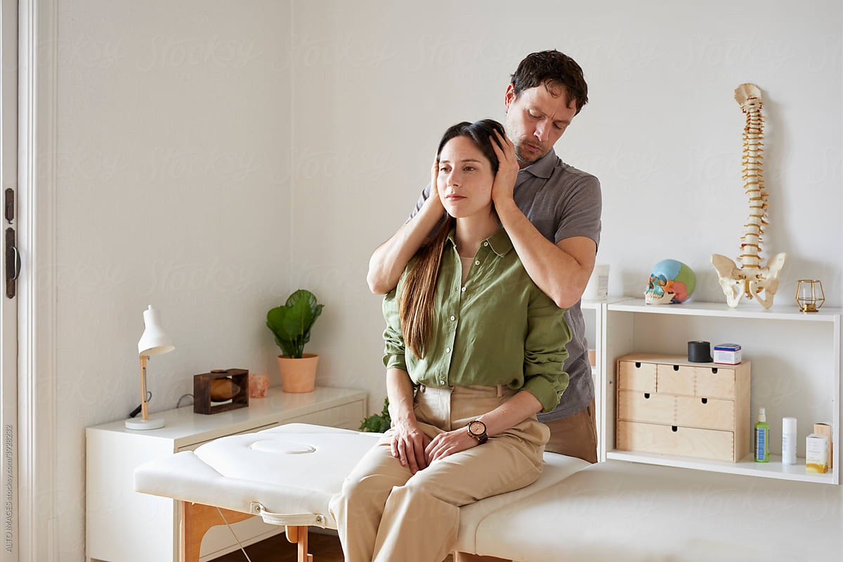 An osteopath treating cervical pain