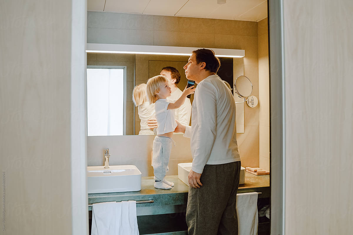 Father and son in the bathroom in front of the mirror