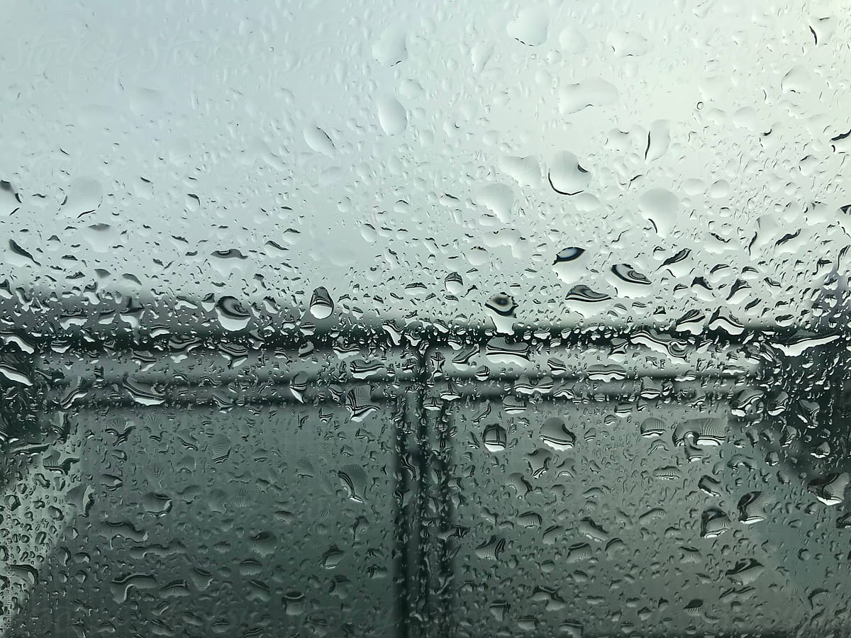Close up of raindrops on passenger ferry boat window, Seattle, Washington