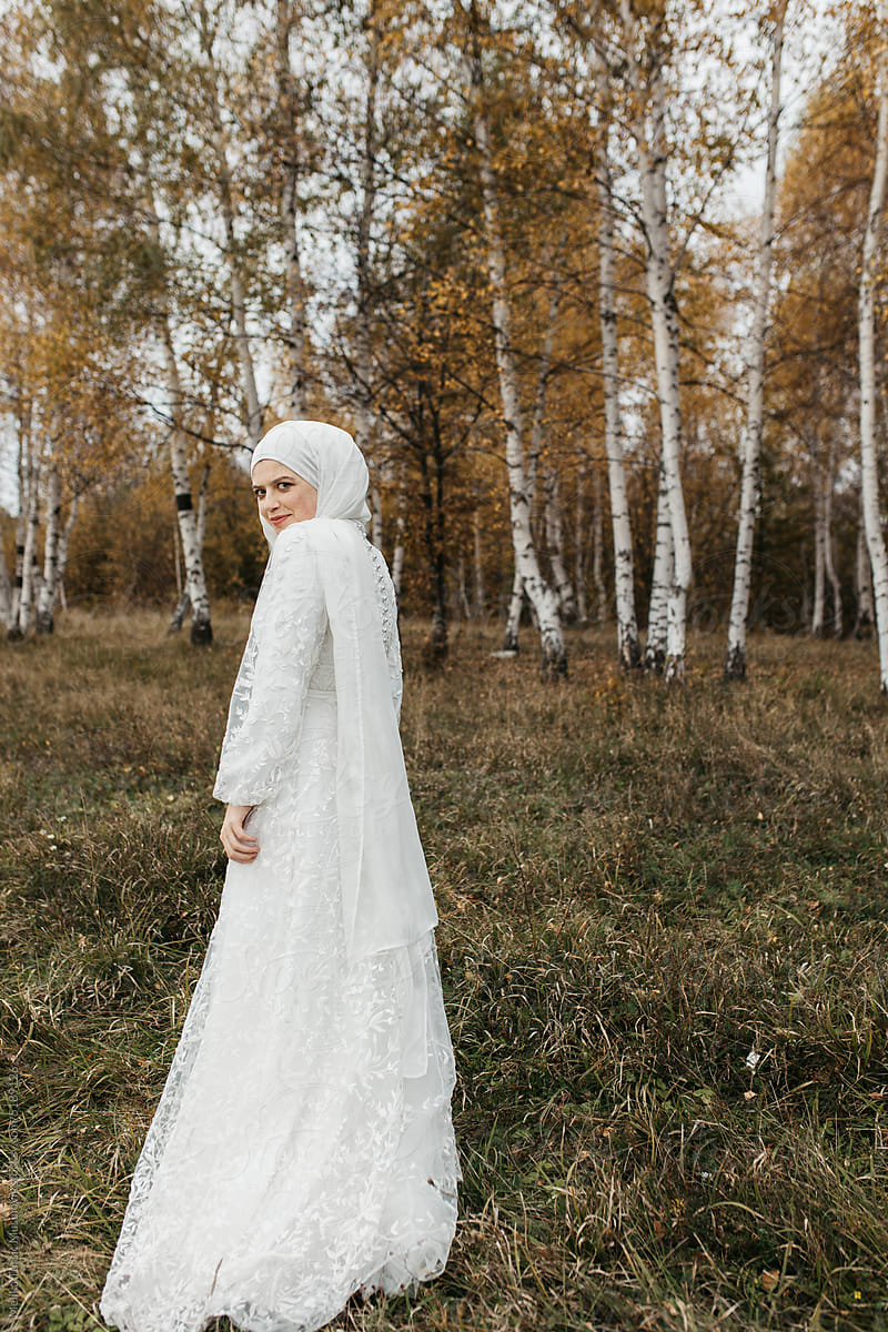 beautiful elegant hijabie bride walking and looking back