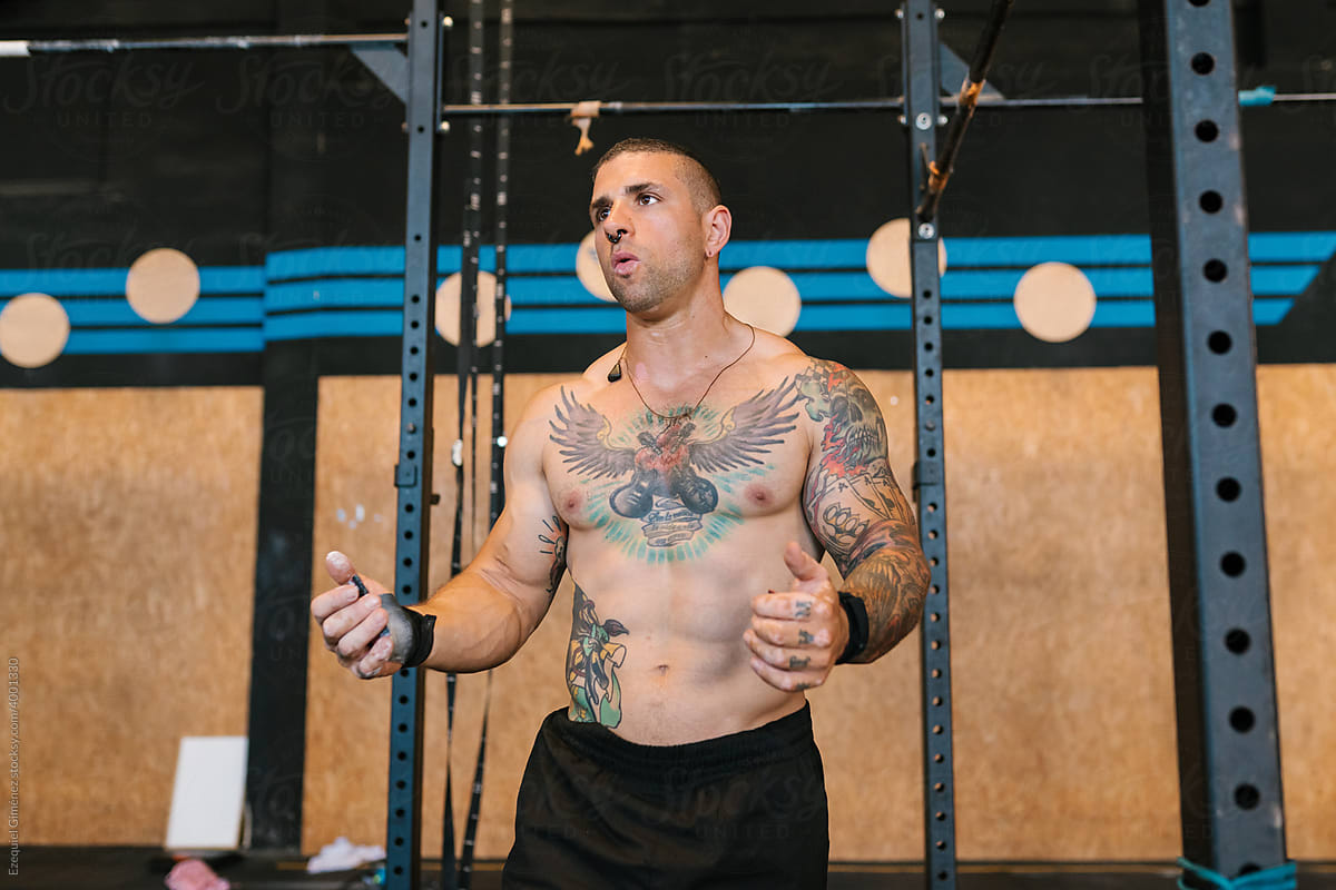 Tattooed coach talking during workout