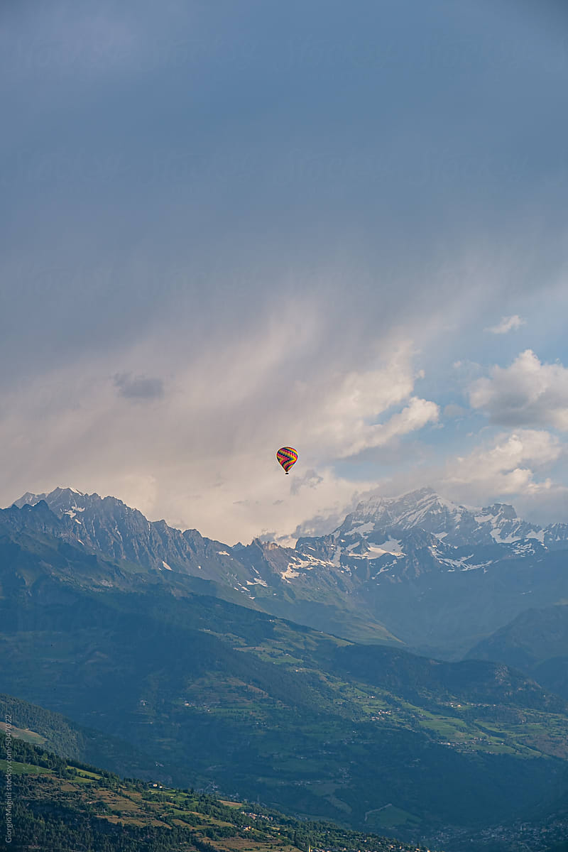 Hot-Air Balloon Flying OverItalian Valley in Summer