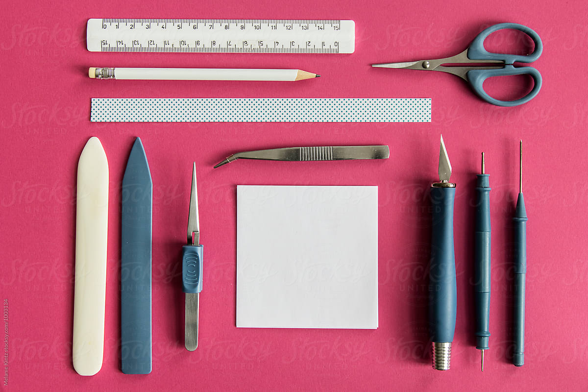 Papercraft tools on pink background
