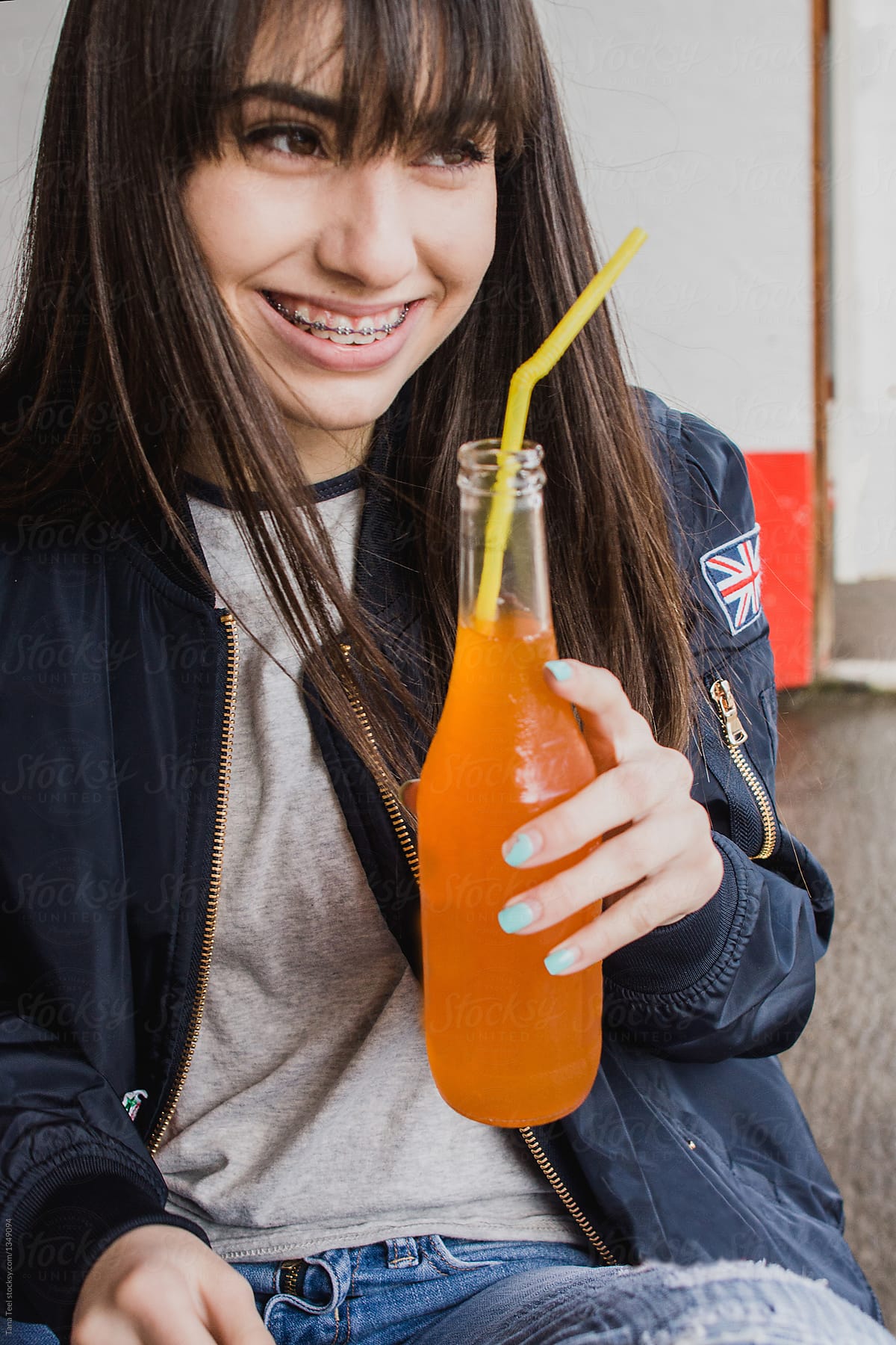 teenager drinking orange soda pop